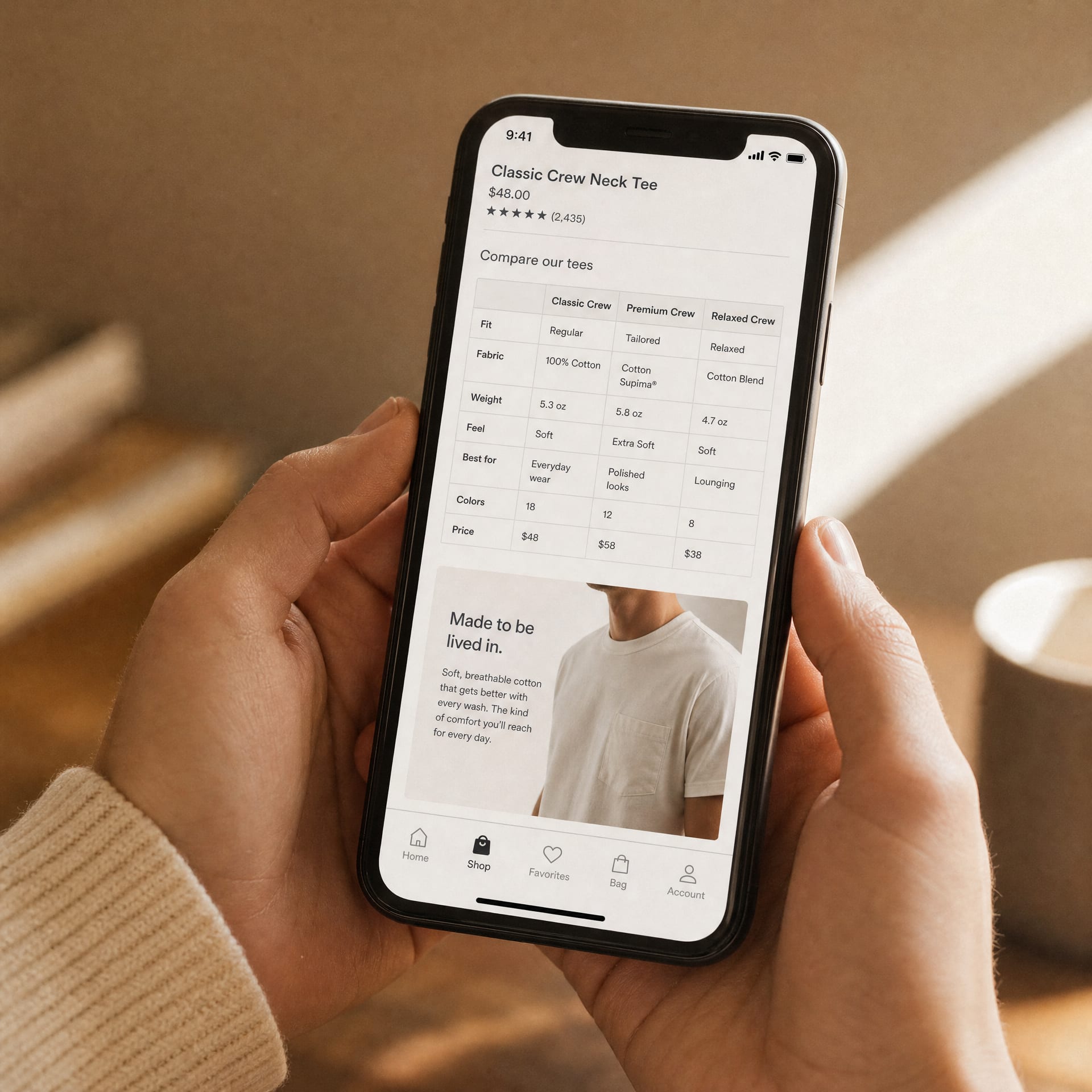 A phone held in both hands, the screen showing an Amazon product detail page scrolled to the A+ Content section, a comparison chart module and an image-with-text module visible above the Amazon app navigation bar.