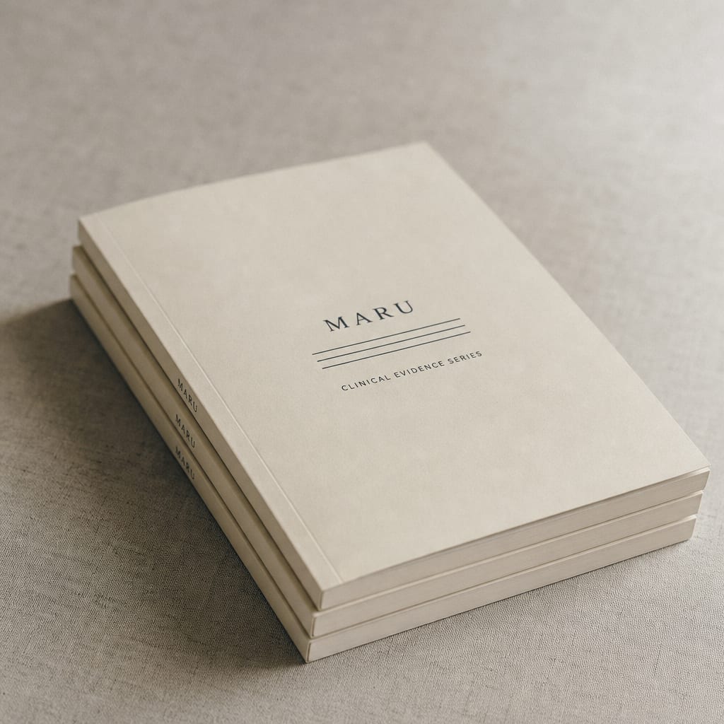 Three slim cream softcover pharma whitepapers stacked under a small Maru wordmark, on pale grey linen.