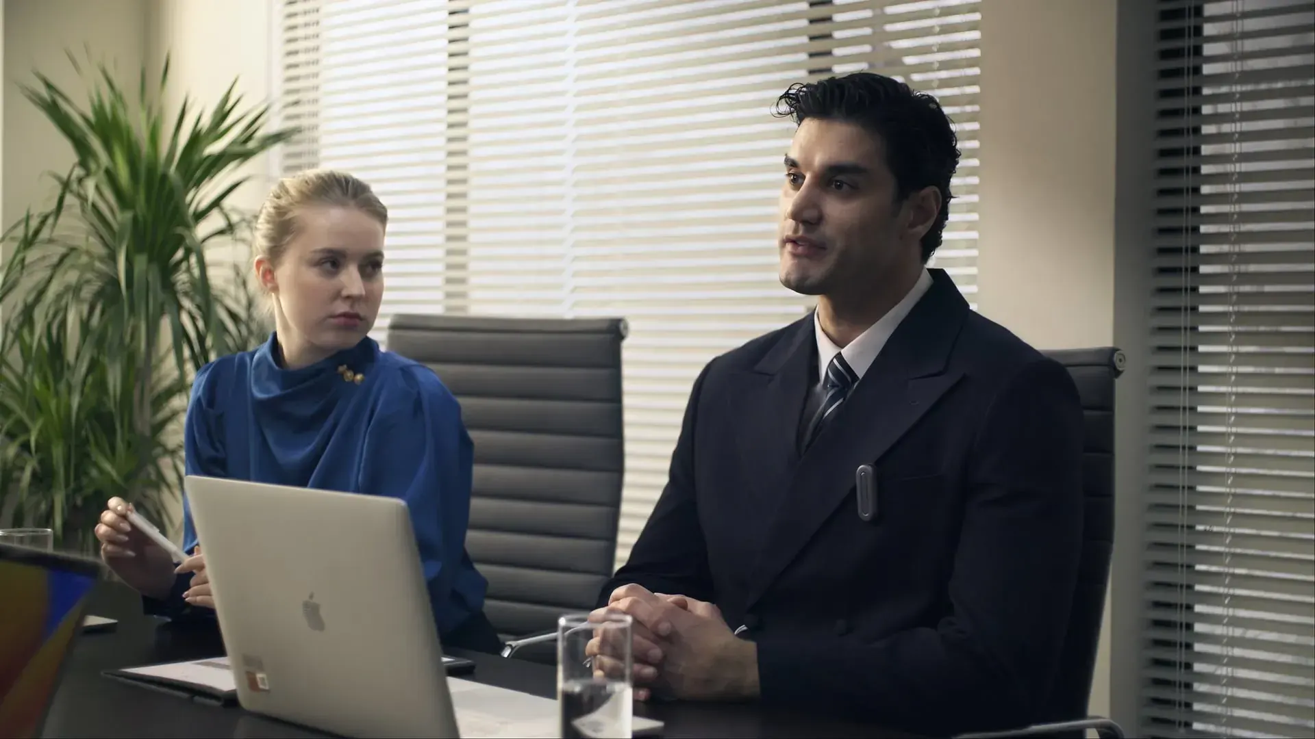A frame from the iFlytek Anypin launch film showing the AI wearable pin clipped to a jacket in a cinematic product moment.