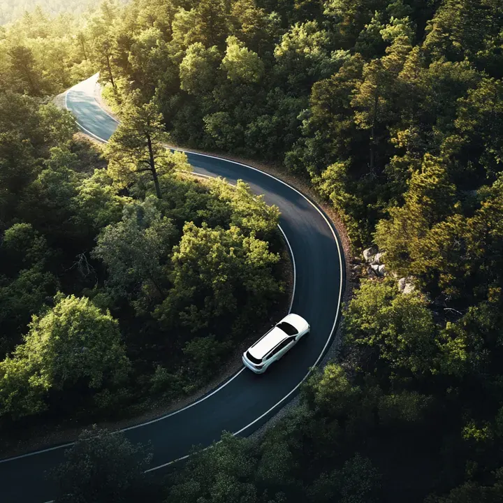The premium SUV shown in a mountain-route landscape.